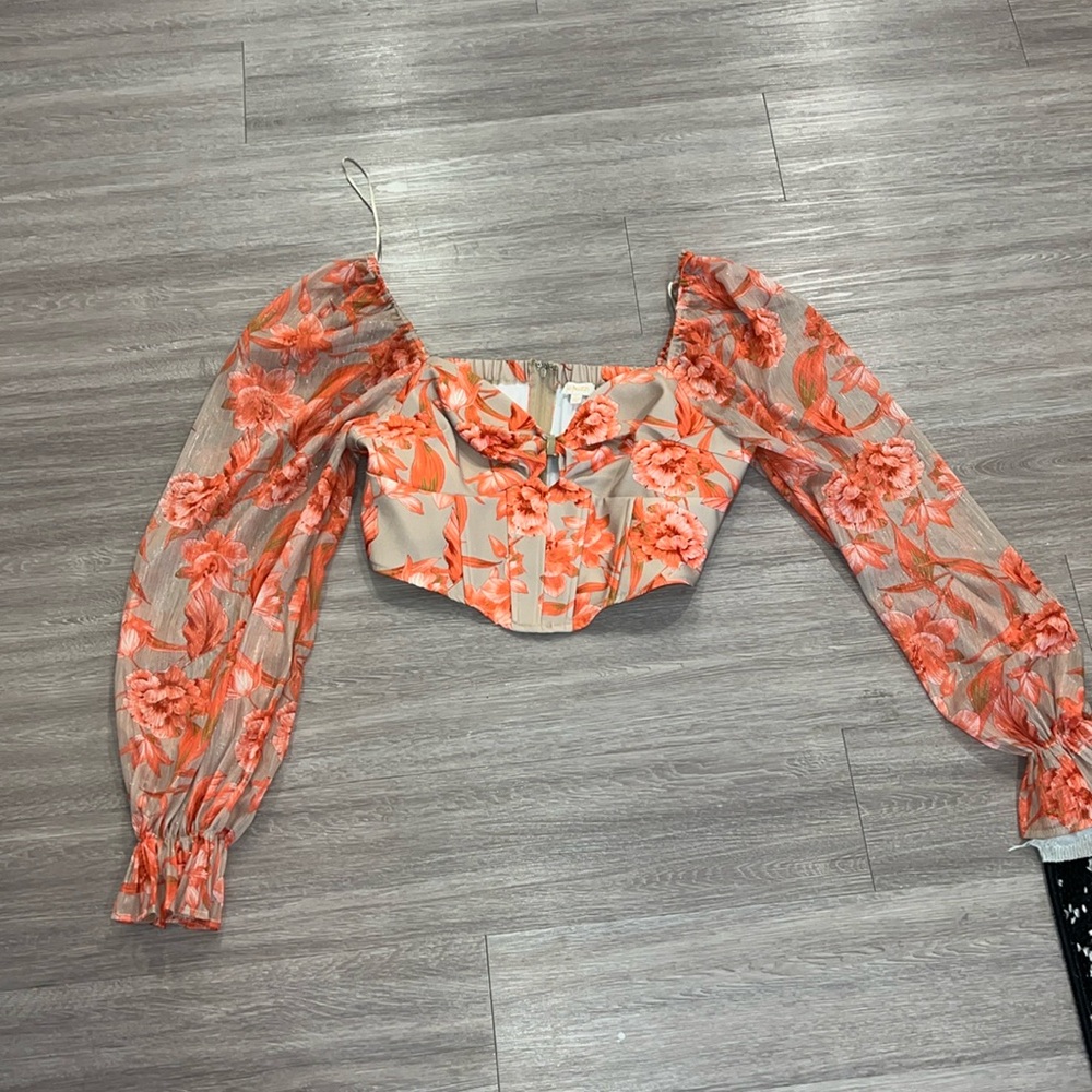 a peach corset crop top with puffy sleeves